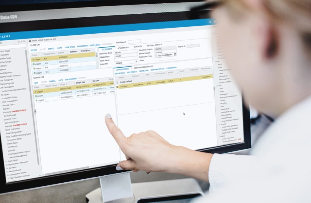 Woman lab employee reviews data in the STARLIMS laboratory information management system (LIMS) for R&D and Quality Manufacturing.