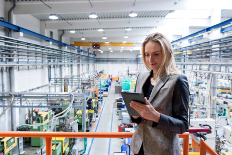 Woman looking at a tablet in a factory